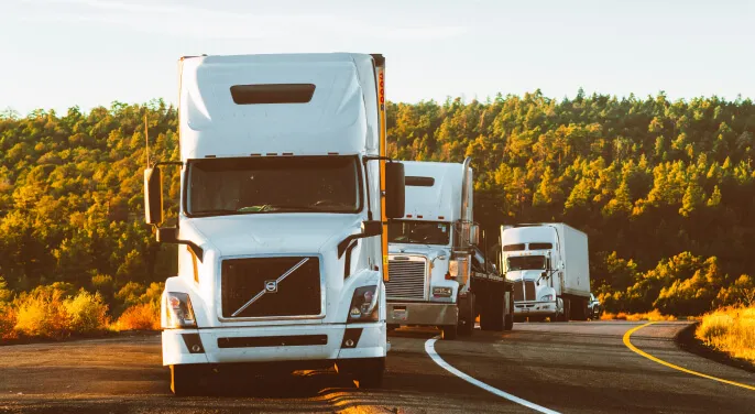 Freight trucks transporting goods by road